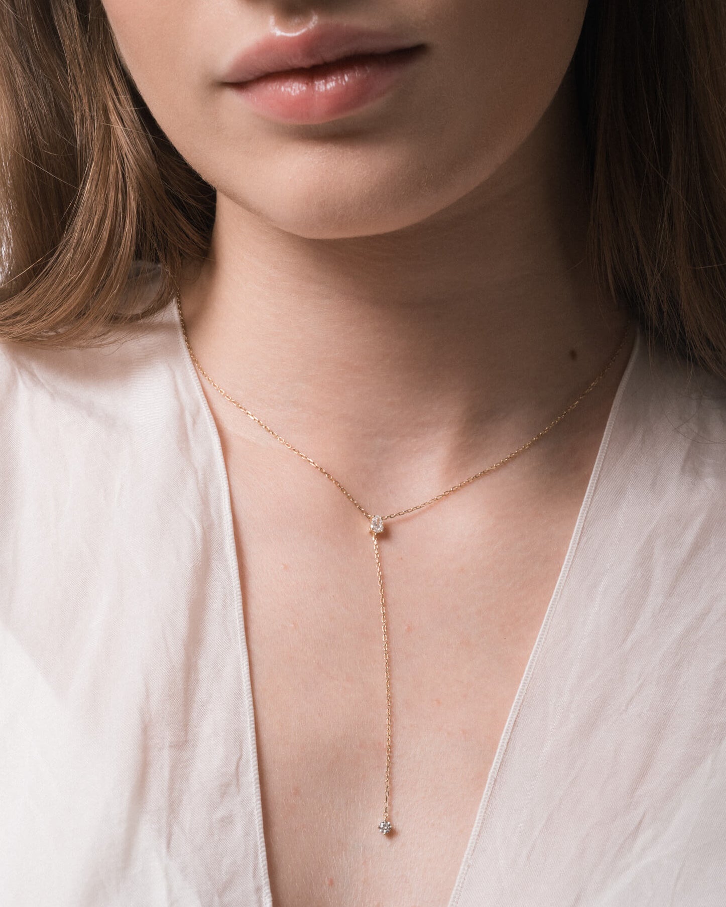 Model wearing the Kaia pear diamond tie necklace in solid yellow gold by Anate, worn on neck