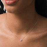 Model wearing the Elara reversible oval diamond pendant in solid white gold by Anate, worn on model, close-up