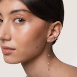 Model wearing the Aura round diamond drop earrings in solid white gold by Anate, worn on ear
