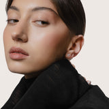 Model wearing the Astra round diamond stud earrings in solid white gold by Anate, worn on ear variant--0.25ct