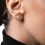 Model wearing the Astra round diamond stud earrings in solid white gold by Anate, worn on ear variant--0.50ct