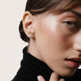 Model wearing the Astra round diamond stud earrings in solid white gold by Anate, worn on ear variant--0.50ct