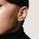 Model wearing the Astra round diamond stud earrings in solid white gold by Anate, worn on ear