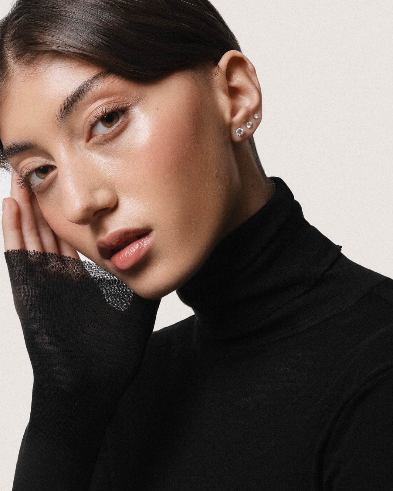 Model wearing the Astra round diamond stud earrings in solid white gold by Anate, worn on ear