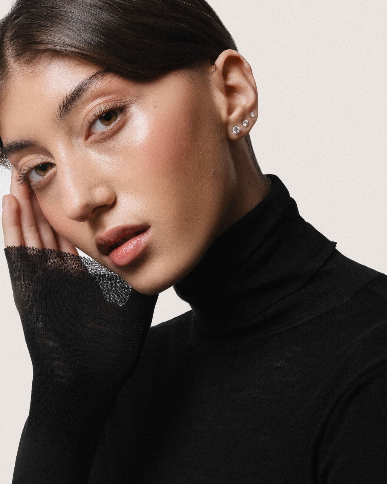 Model wearing the Astra round diamond stud earrings in solid white gold by Anate, worn on ear