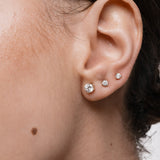 Model wearing the Astra round diamond stud earrings in solid yellow gold by Anate, worn on ear