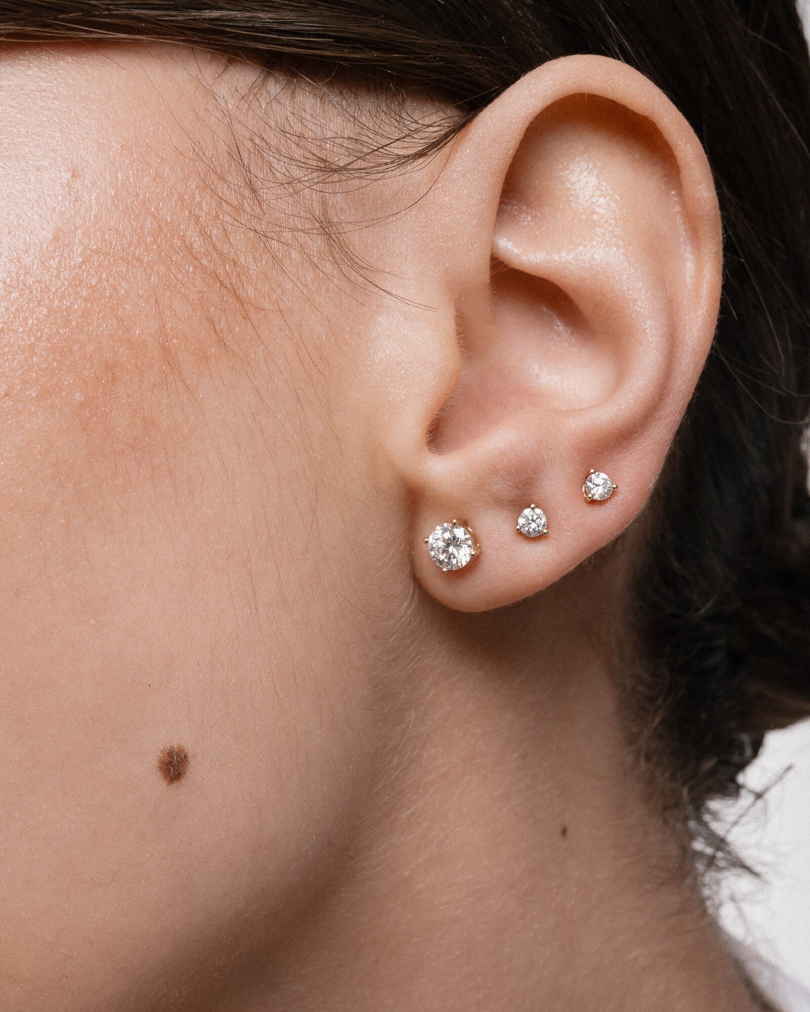 Model wearing the Astra round diamond stud earrings in solid yellow gold by Anate, worn on ear