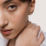Model wearing the Astra round diamond stud earrings in solid yellow gold by Anate, worn on model, portrait shot