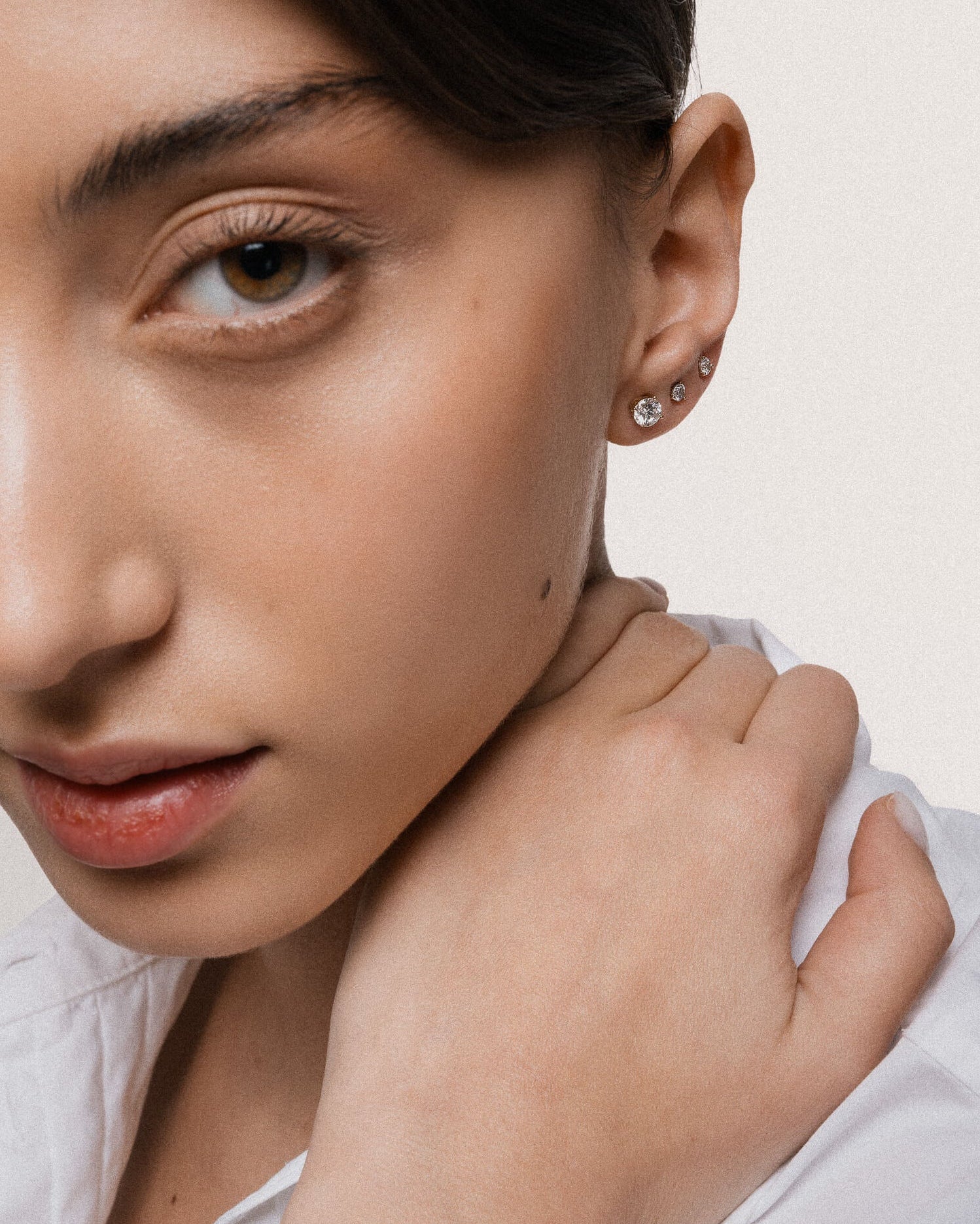 Model wearing the Astra round diamond stud earrings in solid yellow gold by Anate, worn on model, portrait shot