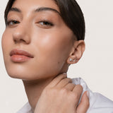 Model wearing the Astra round diamond stud earrings in solid yellow gold by Anate, worn on model, portrait shot