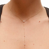 Model wearing the Luna round diamond tie necklace in solid yellow gold by Anaté, worn on neck