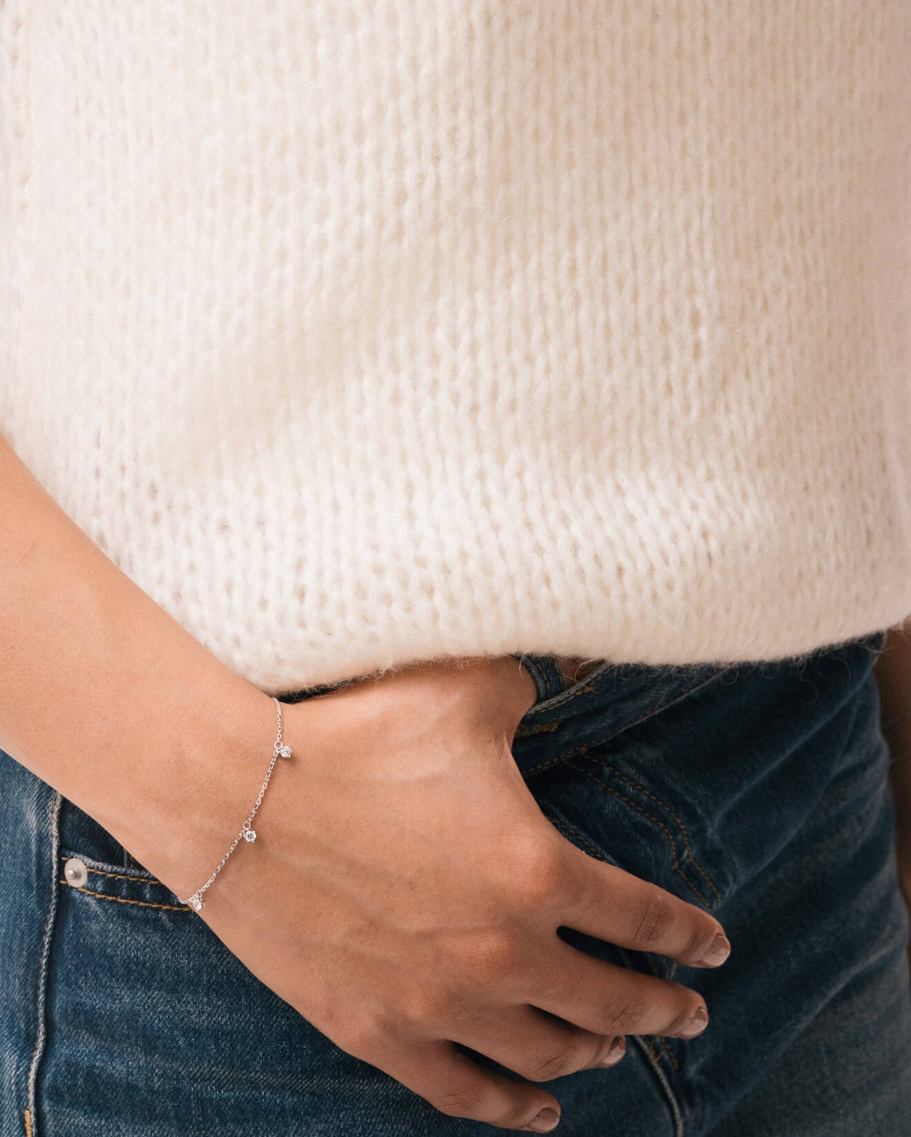 Model wearing the Tria three diamond bracelet in solid white gold by Anate, worn on wrist