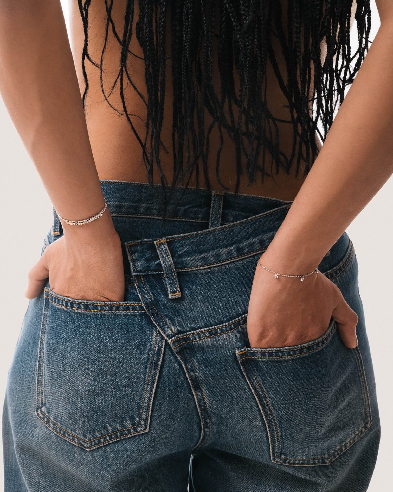 Model wearing the Tria three diamond bracelet in solid white gold by Anate, worn on wrist