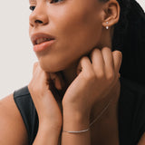 Model wearing the Tria three diamond bracelet in solid white gold by Anate, worn on wrist