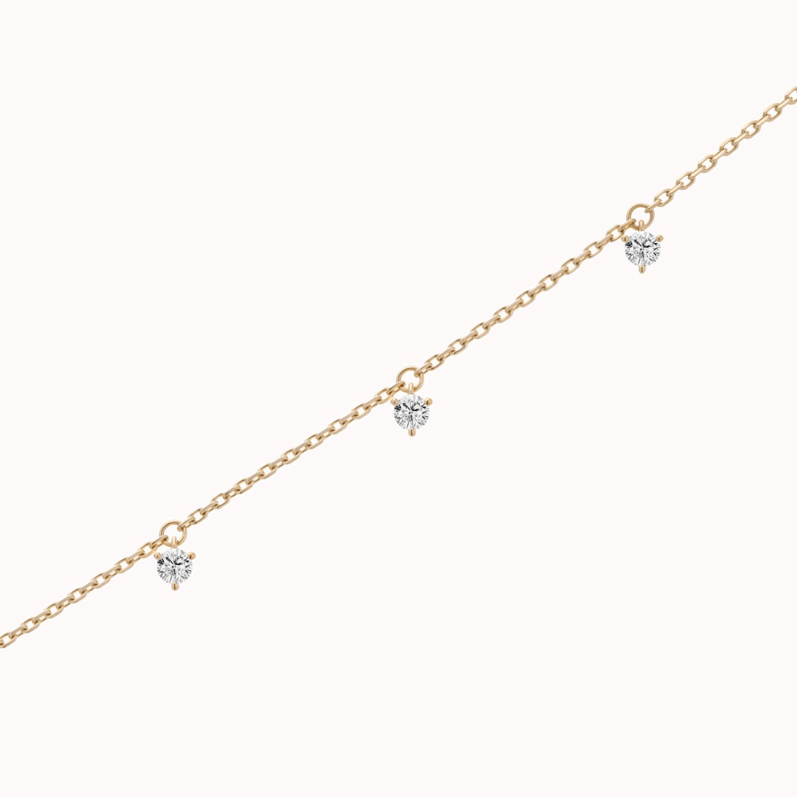 Tria three diamond bracelet in solid yellow gold by Anate, three-quarter angle view