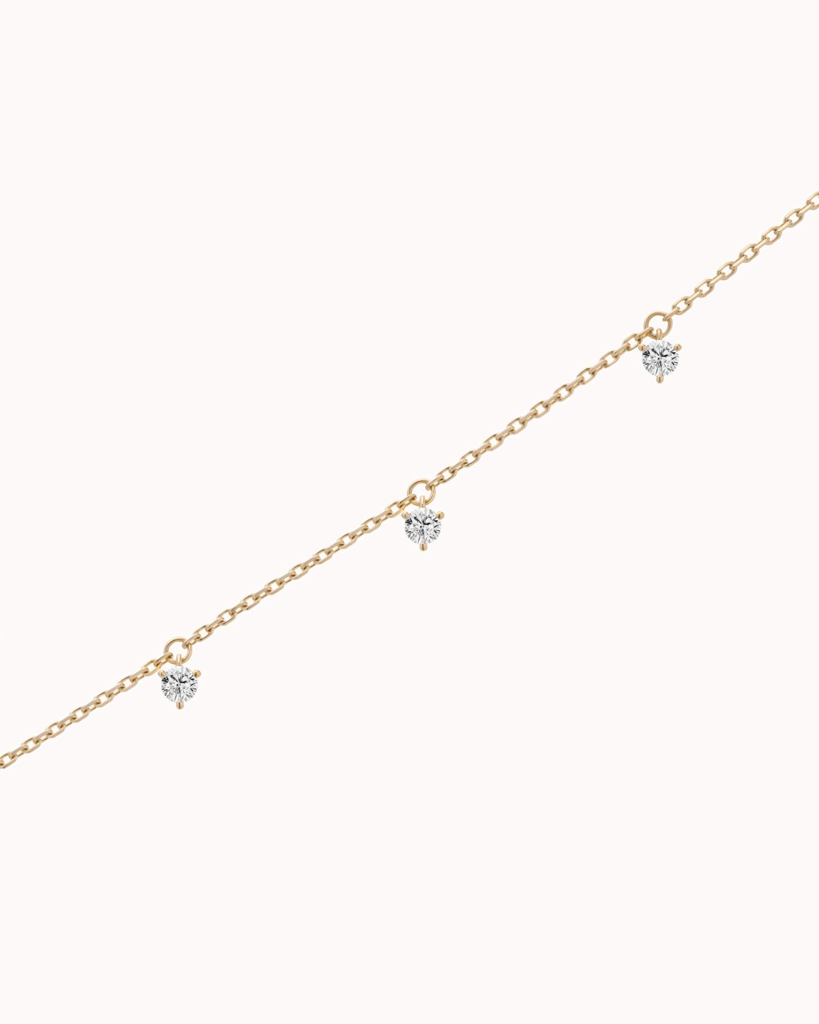 Tria three diamond bracelet in solid yellow gold by Anate, three-quarter angle view