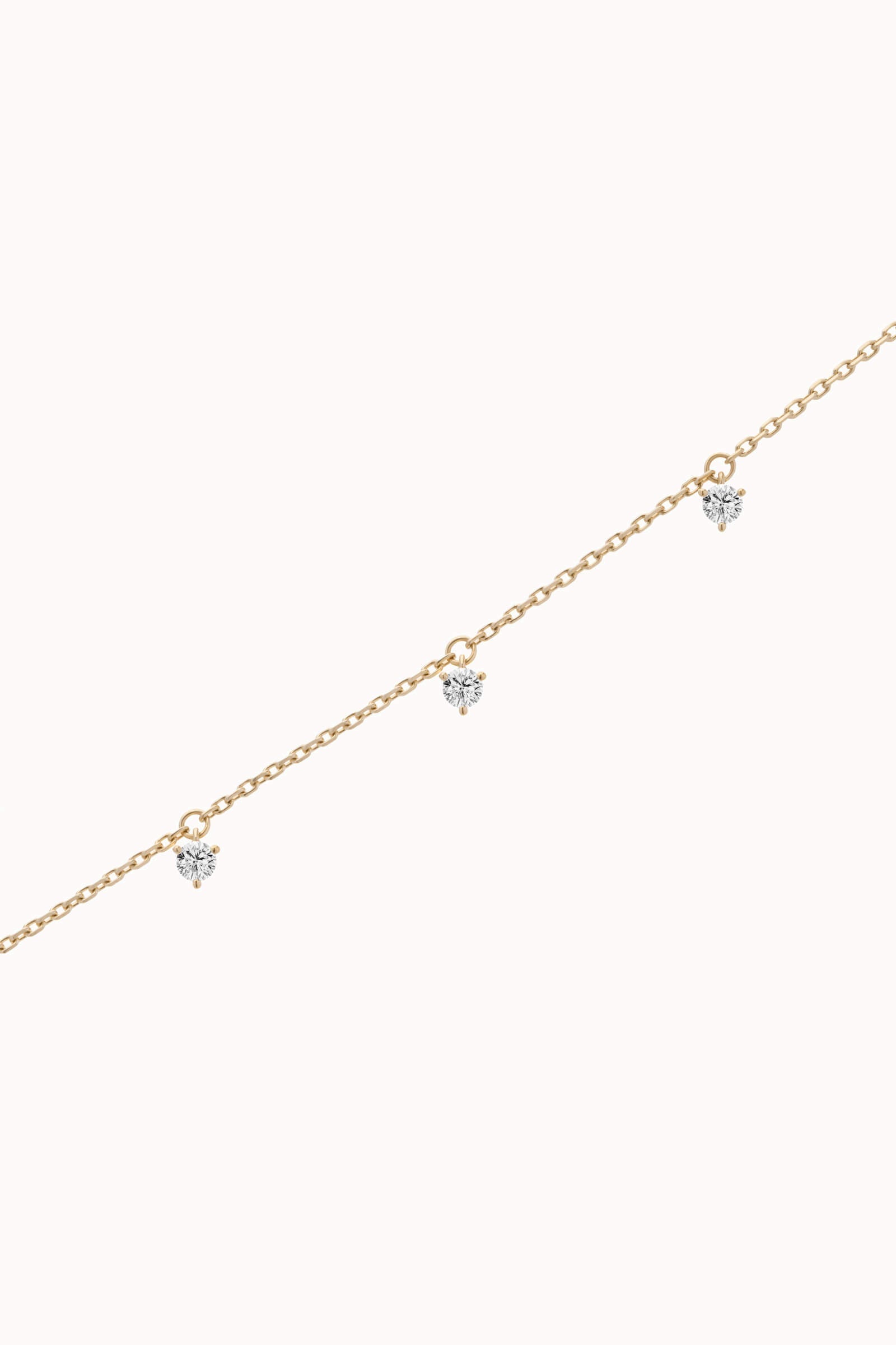 Tria three diamond bracelet in solid yellow gold by Anate, three-quarter angle view