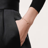 Model wearing the Tria three diamond bracelet in solid yellow gold by Anate, worn on wrist