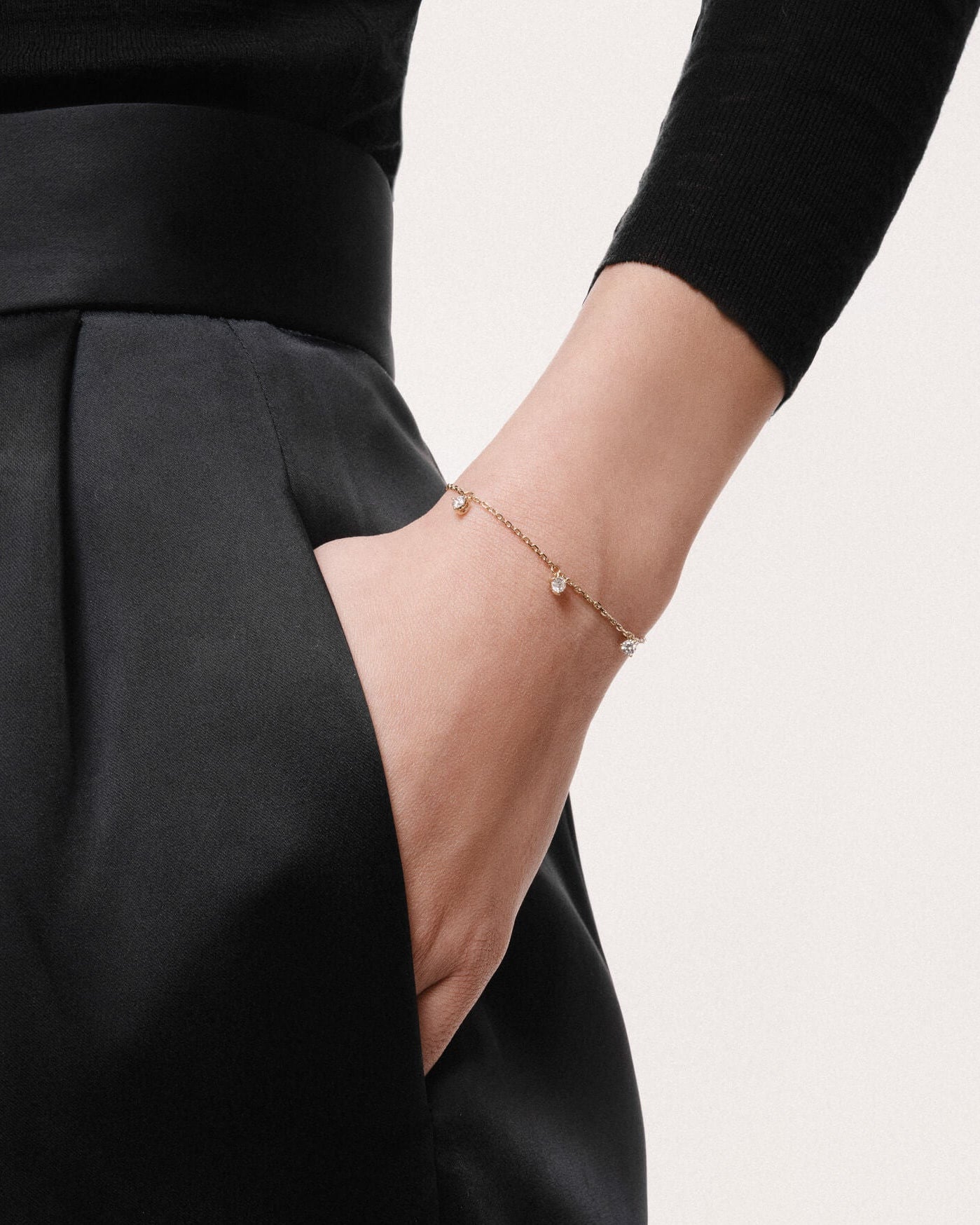 Model wearing the Tria three diamond bracelet in solid yellow gold by Anate, worn on wrist