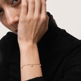 Model wearing the Tria three diamond bracelet in solid yellow gold by Anate, worn on wrist