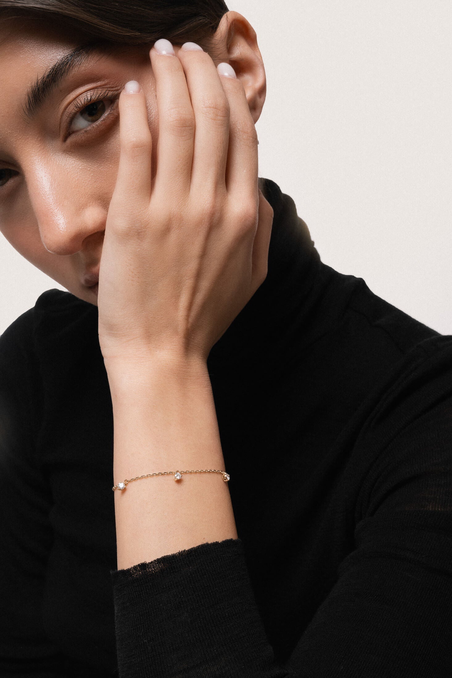 Model wearing the Tria three diamond bracelet in solid yellow gold by Anate, worn on wrist