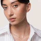 Model wearing the Elio three diamond necklace in solid white gold by Anate, worn on model, portrait shot