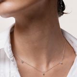 Model wearing the Elio three diamond necklace in solid white gold by Anate, worn on neck